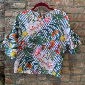 Ruffle shoulder, tropical print blouse.